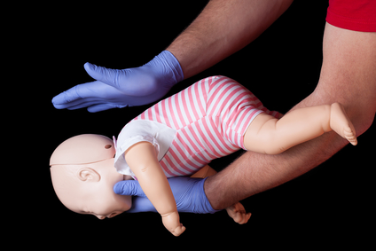 Doctor showing first aid for choking infant