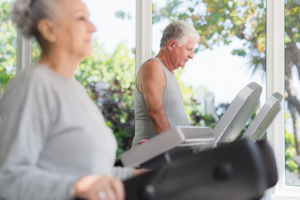 People and sports, elderly couple working out on treadmill in fitness gym