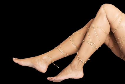 Legs pain concept - legs tied with rope isolated